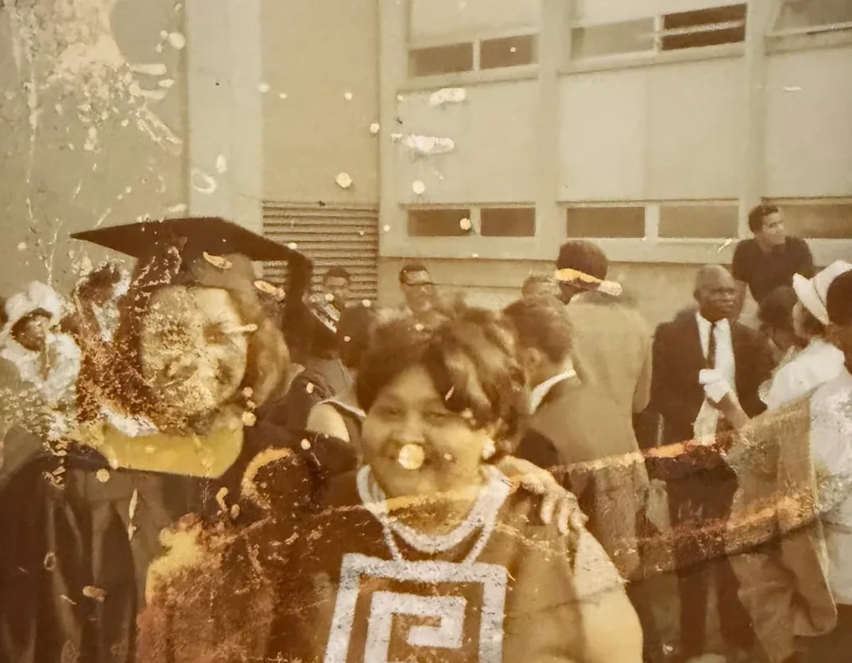 Before — A graduation day rescued from decades of water damage and stains.